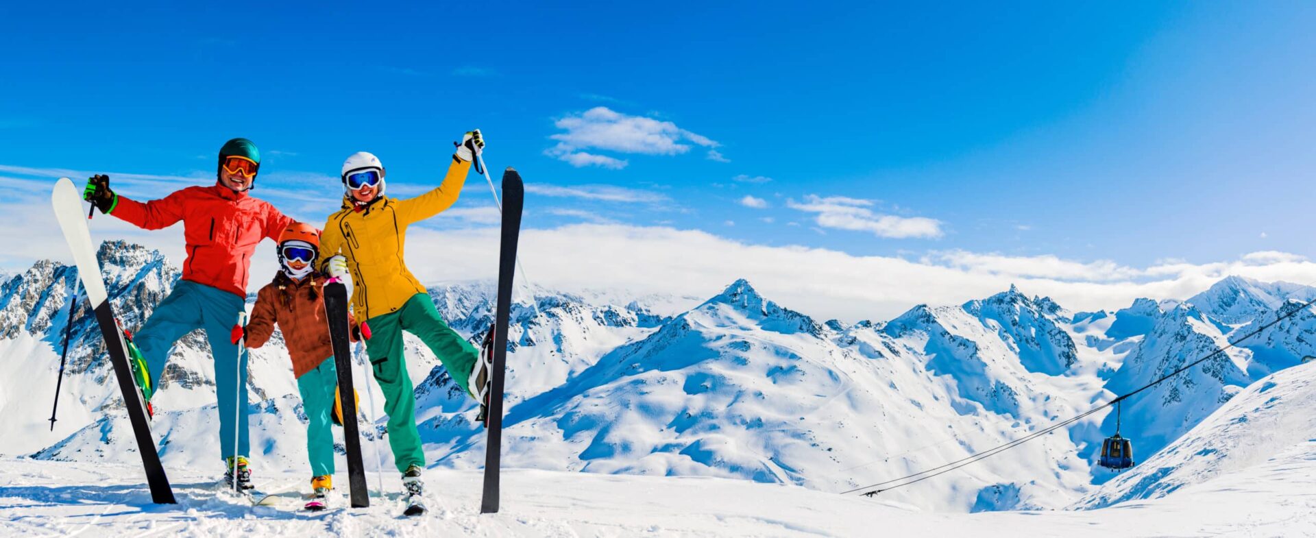 Happy family enjoying winter vacations in mountains, Val Thorens, 3 Valleys, France. Playing with snow and sun in high mountains. Winter holidays.