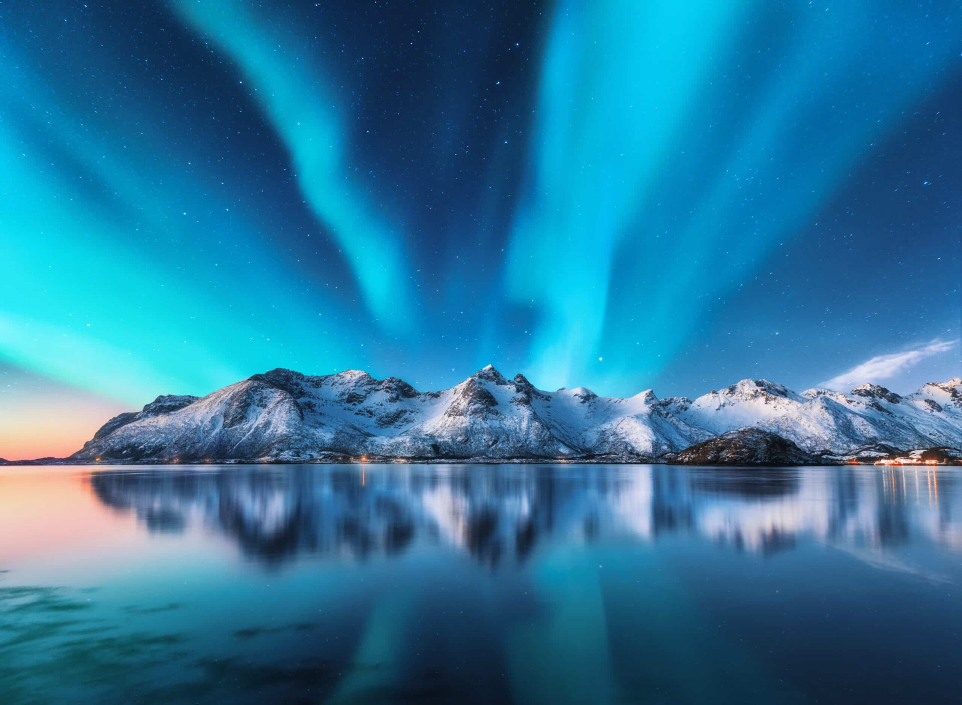 Northern lights and snow covered mountains in Lofoten islands, N